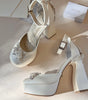 Zapatillas de novia con un tacón ancho y una correa gruesa, decoradas con cristal austriaco y perla bordada en su parte delantera y trasera.